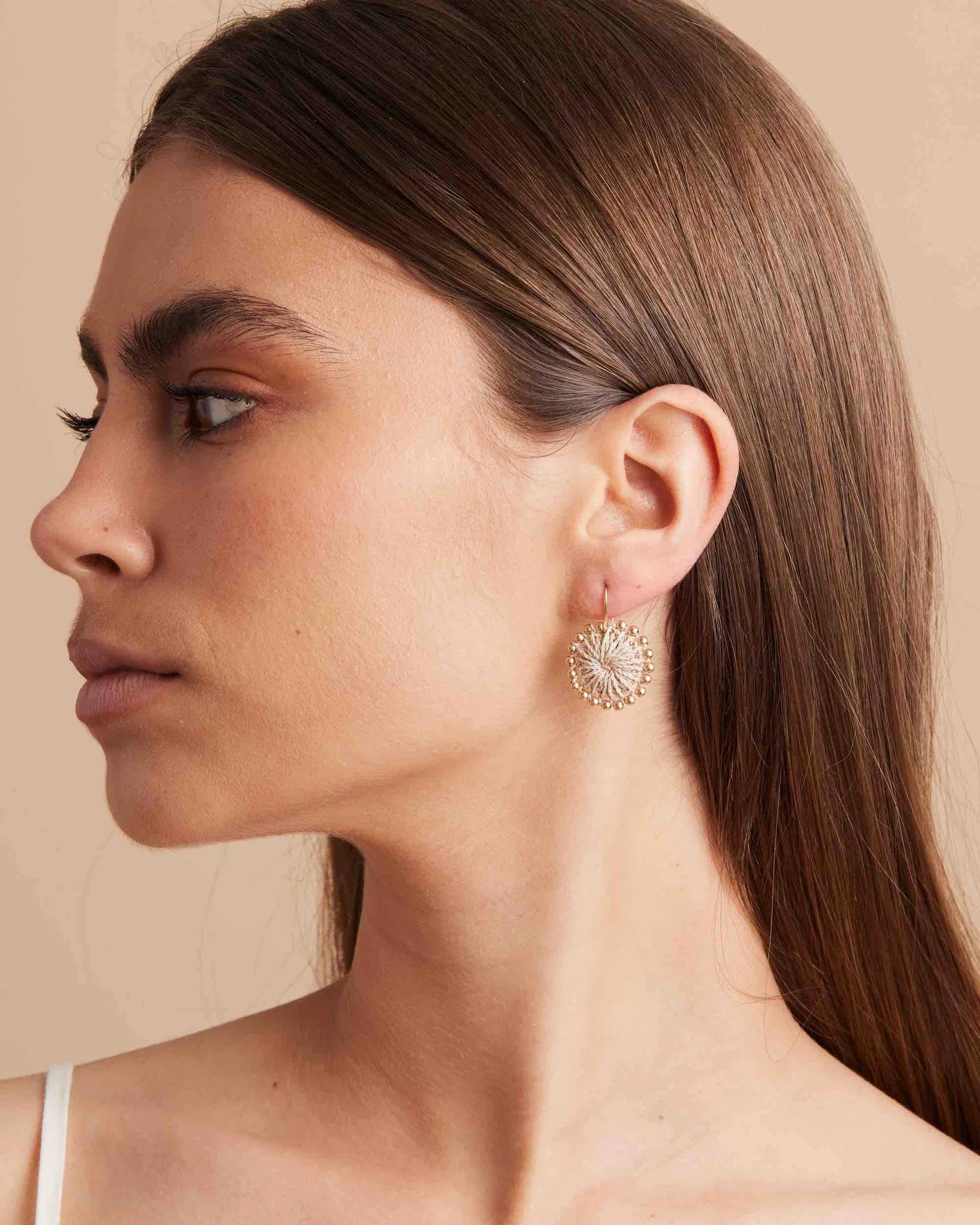 Natural-Woven-Disc-Earrings-with-Gold-Beading-side-model-Bilum-and-Bilas.webp